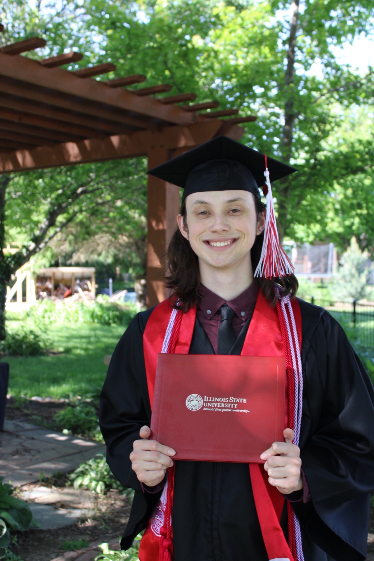 Image of Graham holding his diploma